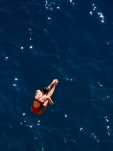 dive, swimmer, jump, sport, competition, speed, woman, athlete, health, strength, human, movement, sporty, active, travel wellness, exercise, nature, swimsuit, youth, beautiful, red, professional, diver, high, sea, that